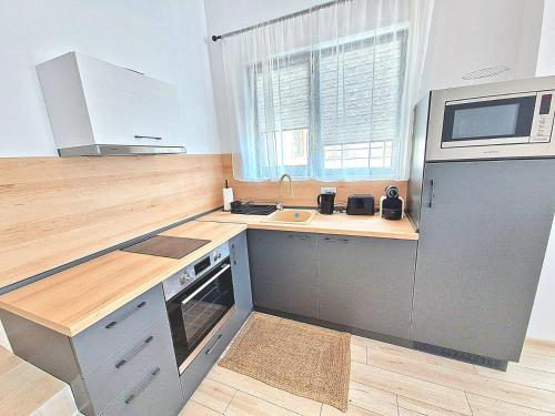 a kitchen with a sink and a microwave at Cabacum Paradise 1 on the seashore in Varna City