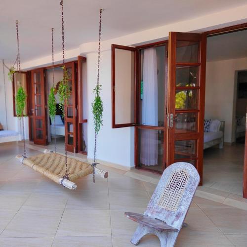 a swing in a living room with a chair at Beach Front Luxury 2 Bedroom Mombasa in Mombasa