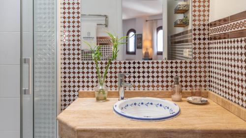 a bathroom with a sink and a mirror at Casa Arcos de Almona Frigiliana by Ruralidays in Frigiliana