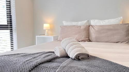 a bedroom with a bed with a towel on it at La Bella Vita Bellamare in Summerstrand