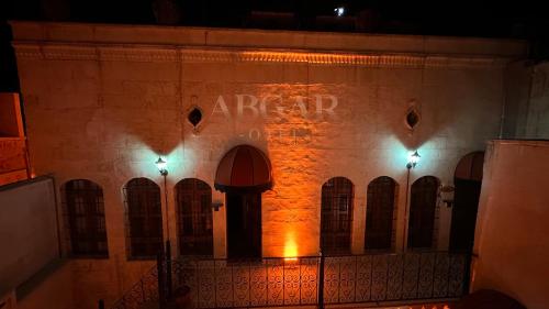 a building with a sign on the side of it at night at ABGAR Otel in Sanlıurfa