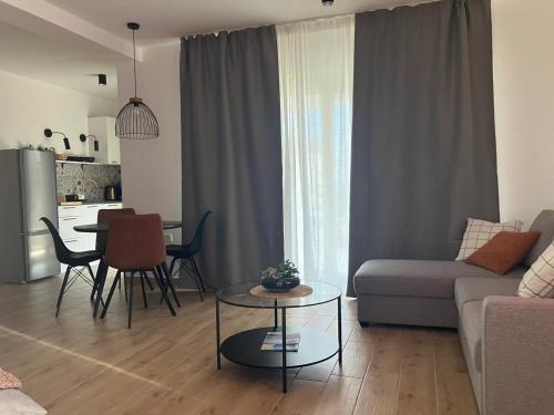 a living room with a couch and a table at Apartment Oblica-beautiful new, well equipped apartment in Kastav