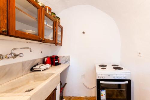 a kitchen with a sink and a stove at Milea Traditional House-Private Garden Retreat in Miléa