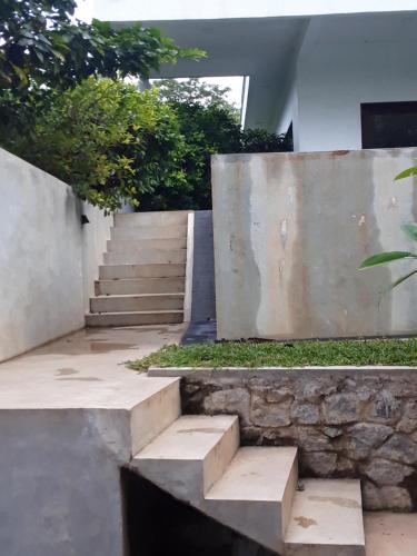 a set of stairs leading up to a house at Thalangama Lakeview Lodge in Battaramulla