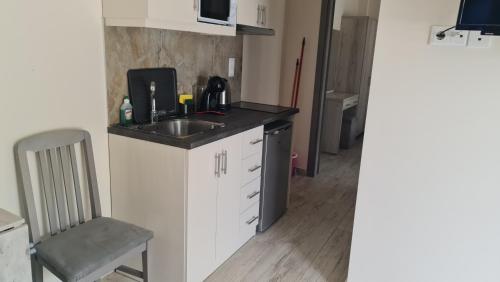 a small kitchen with a sink and a microwave at The Palms novasithonia in Vourvourou
