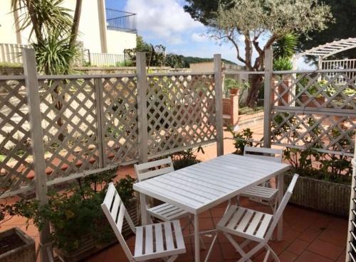 a white table and chairs on a patio at Il Giardinetto - Volcano in Ercolano