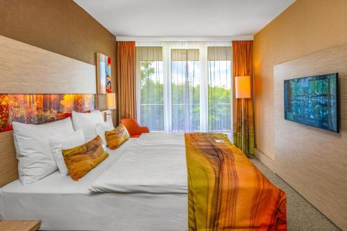 Postel nebo postele na pokoji v ubytování Lifestyle Hotel Mátra