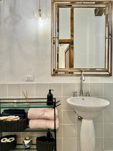 a bathroom with a sink and a mirror and towels at MontalciNest in Montalcino