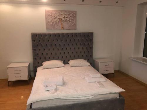 a bedroom with a large bed with two night stands at Причал in Kyiv