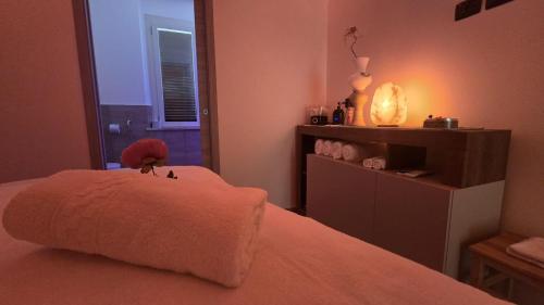 a bedroom with a bed with a stuffed animal on it at I Fiori di Margherita Luxury B&B in Perugia
