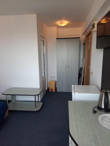 a room with a desk and a table in a room at Genius in Eforie Sud