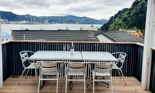 a white table and chairs on a balcony at Ideal location for groups, family, friends or work in Wellington