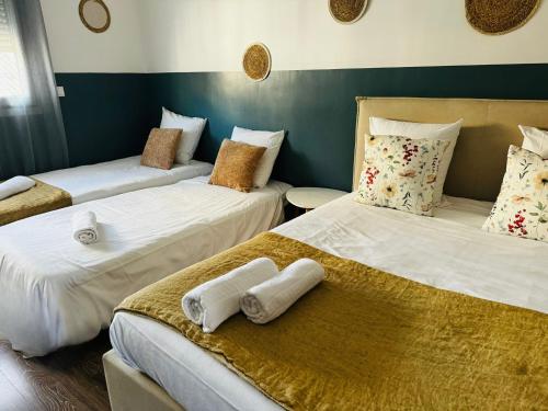 une chambre avec trois lits avec des serviettes dessus dans l'établissement Studio Blancarde Terrasse Parking Clim, à Marseille