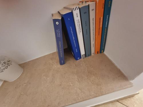 a row of books sitting on a shelf at Casa vacanze San Martino in Ginosa