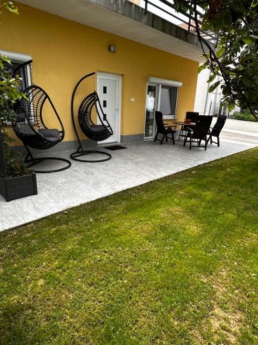 a patio with chairs and a table in a house at RIAD Apartments Premium in Zgornje Škofije