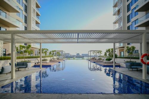 an external view of a swimming pool in a building at Juman flat Marina and Sea view in Ḩayl Āl ‘Umayr