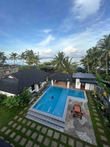 an aerial view of a house with a swimming pool at 3 Storey Beachfront Villa with Pool by JCV in Nasugbu