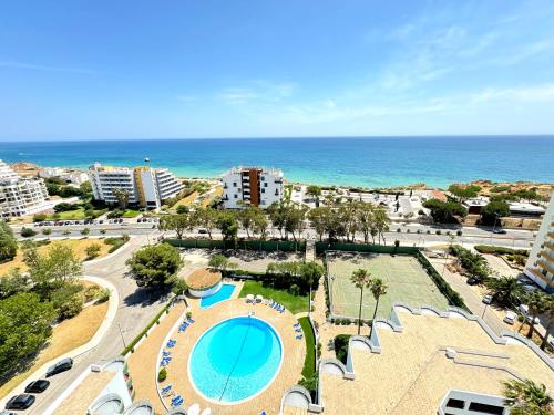 an aerial view of a resort with the ocean at Top Ocean View Apartment - amazing sunset - modern style - pool & 200m to beach in Portimão