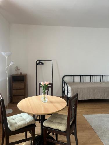 a room with a table and chairs and a bed at Apartman VAJB in Jičín