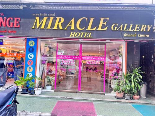 a marle gallery hotel with pink doors and plants at Miracle Gallery Hotel in Makkasan