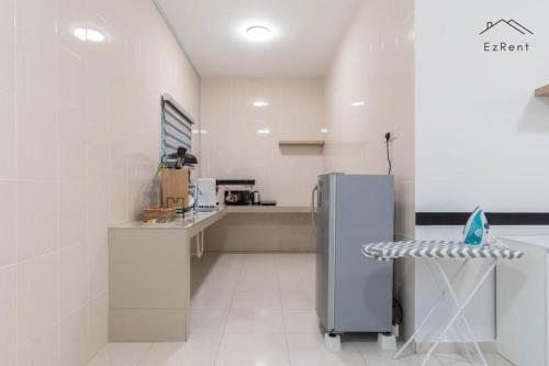 a white kitchen with a refrigerator and a counter at Semi-D Black & White Retreat with Free NetFlix WiFi in Taiping
