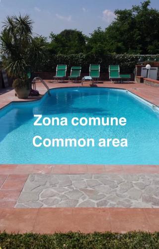 a swimming pool with a sign that reads zona committee common area at Il Giardinetto - Volcano in Ercolano