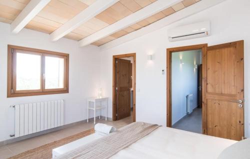 a white bedroom with a large bed and a window at Son Sec Nou in Ses Covetes