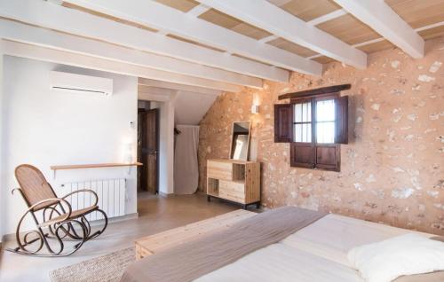 a bedroom with a bed and a chair in a room at Son Sec Nou in Ses Covetes