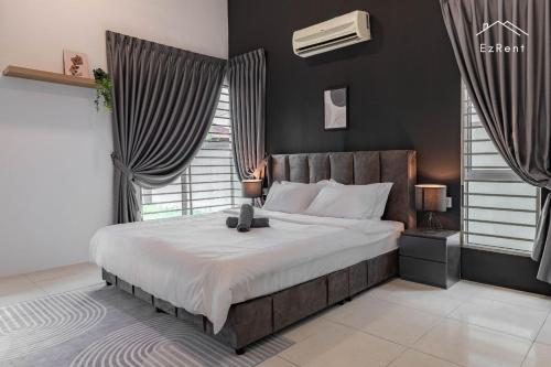 a bedroom with a large bed in a room with windows at Semi-D Black & White Retreat with Free NetFlix WiFi in Taiping