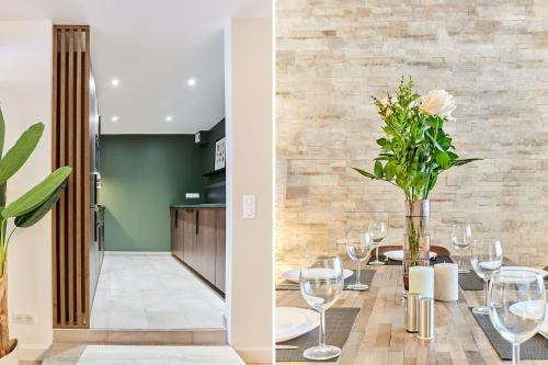 une salle à manger avec une table et des verres à vin dans l'établissement Résidence Montparnasse by Studio prestige, à Paris