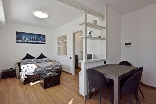 a bedroom with a bed and a desk and a table at Zona Panoramica - Bluchalet in Aosta
