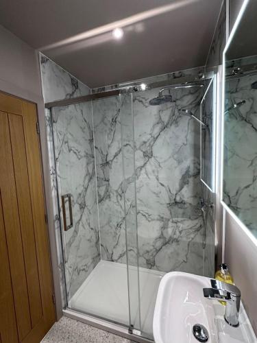 a bathroom with a shower and a sink at Harbourside Apartment No 3 in Tobermory