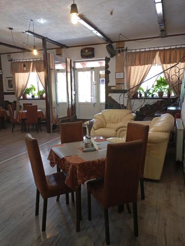 a living room with a table and a couch at Three Aces in Velikaya Dobronʼ
