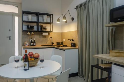 a kitchen with a table with a bowl of fruit on it at Marinusa home luxury - air conditioned - wi-fi in Siracusa