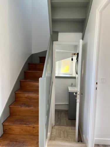 un couloir avec des escaliers, une fenêtre et un lavabo dans l'établissement Maison bretonne typique plage des oiseaux à Fouesnant Beg Meil, à Fouesnant