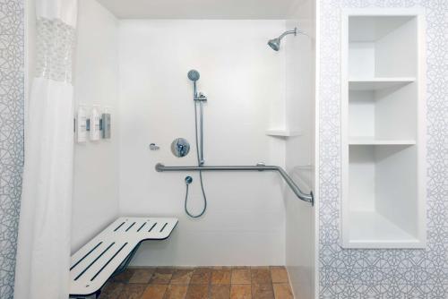 a white shower with a bench in a bathroom at Hampton Inn & Suites Murfreesboro in Murfreesboro