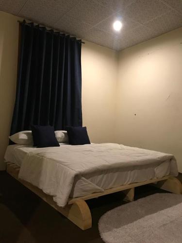 a large bed in a room with a window at Sonzal Hunza in Karimabad Hunza