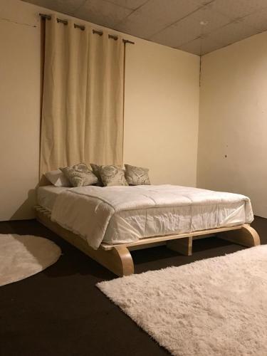 a bed in a room with two rugs at Sonzal Hunza in Karimabad Hunza