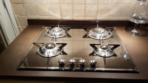 a group of pots on a stove in a kitchen at Casa Il Gufo e la Pupa in Matera