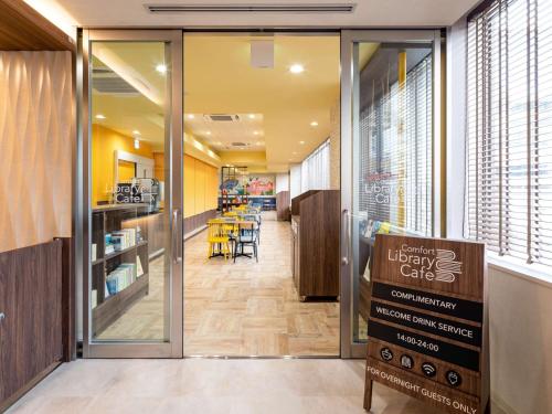 a view of the entrance to a library with a sign at Comfort Hotel Nagoya Meiekiminami in Nagoya