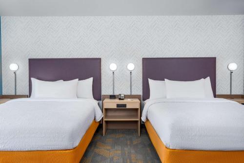 two beds sitting next to each other in a room at Home2 Suites By Hilton Indianapolis North At Intech Park in Indianapolis