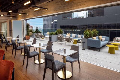 a restaurant with tables and chairs on a patio at Hampton Inn by Hilton New York Times Square in New York