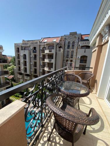 a balcony with chairs and a table on a balcony at Dawn Park Deluxe in Sunny Beach