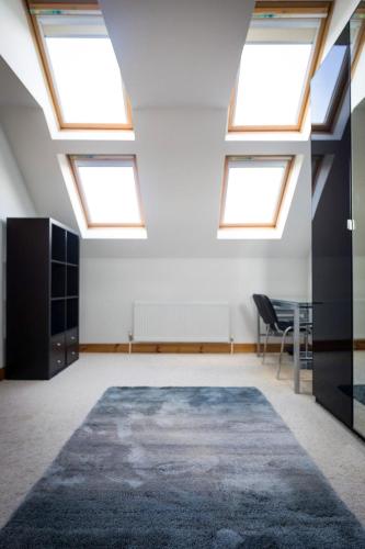 an attic room with skylights and a table and a rug at Morriscastle Seaview House Kilmuckridge by Trident Holiday Homes in Kilmuckridge