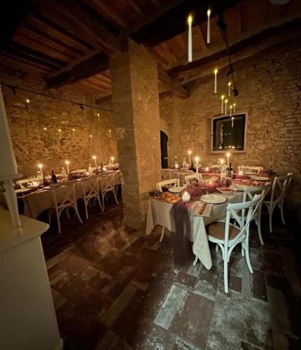 a dining room with long tables and white chairs at punti di vista in Bibbona