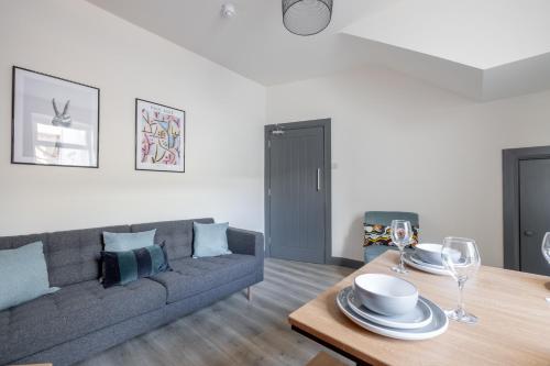 a living room with a couch and a table at City Rooms in Derry Londonderry