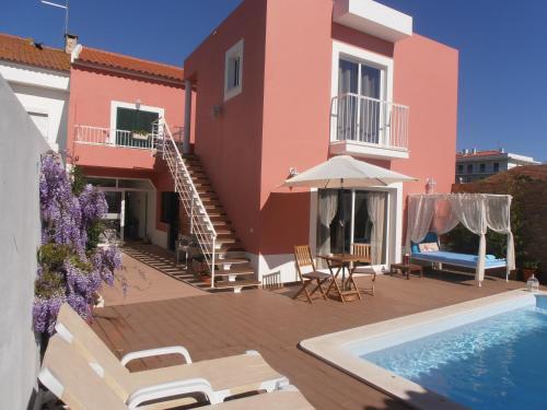 a villa with a swimming pool and a house at Casa Morgados - Grândola Guesthouse in Grândola
