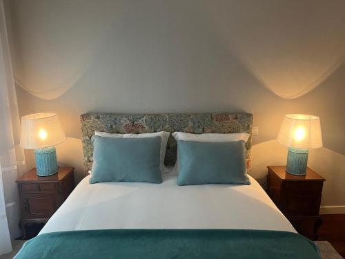 a bedroom with a bed with two lamps on both sides at Fortaleza Faro in Valença