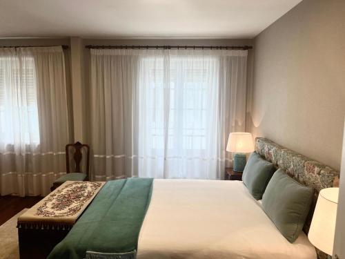 a bedroom with a large bed and a window at Fortaleza Faro in Valença