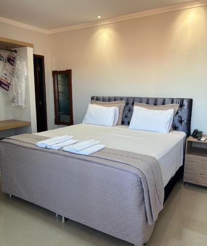 a bedroom with a large bed with two towels on it at Italian Palace Hotel in Sinop